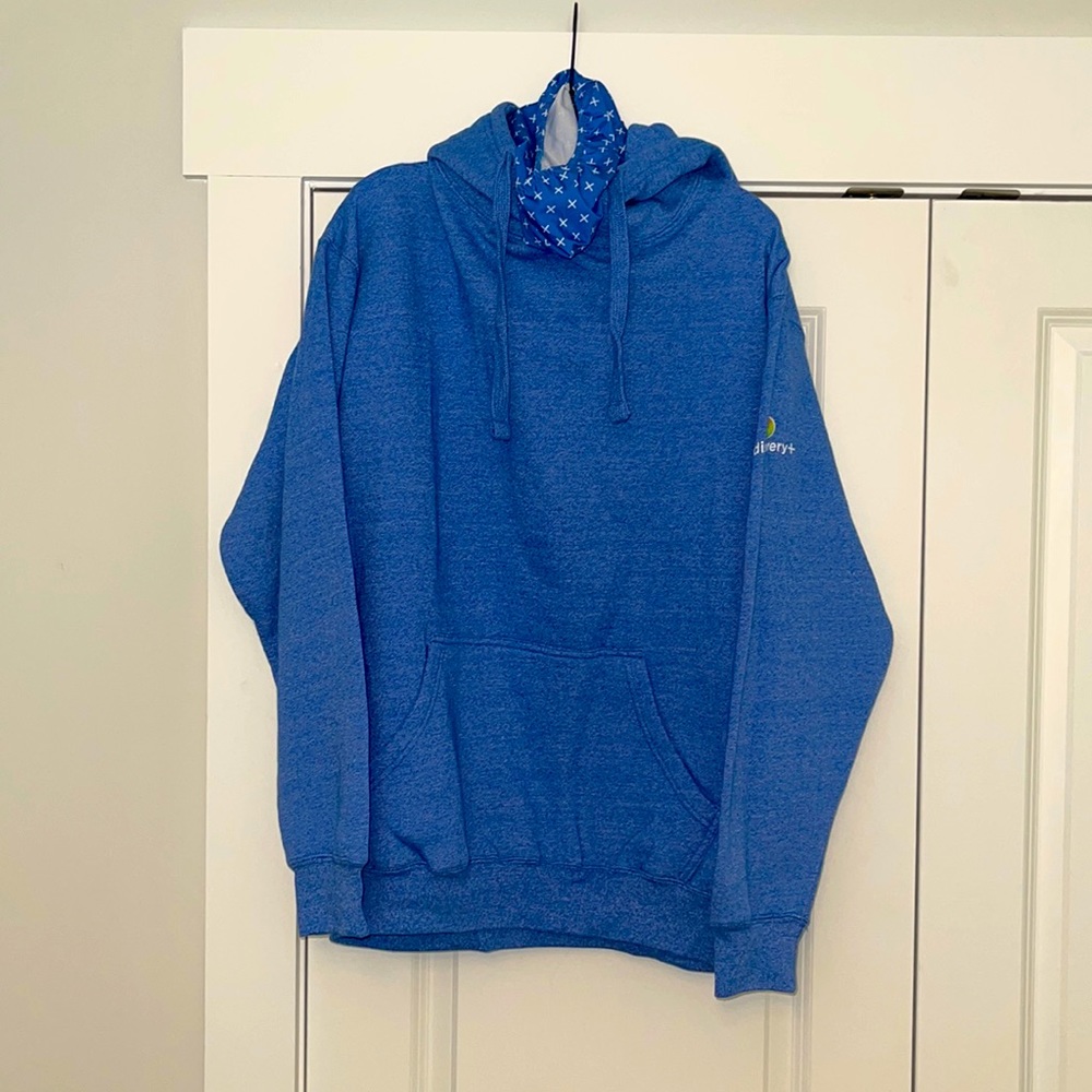 Discovery+ size large hoodie with built in mask light blue in color.